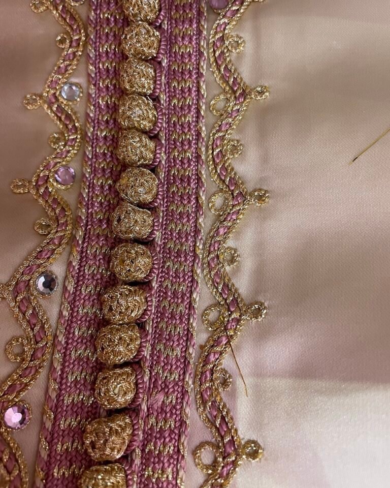 Close-up of hand-stitched sfifa braid and aakad buttons on a Moroccan caftan